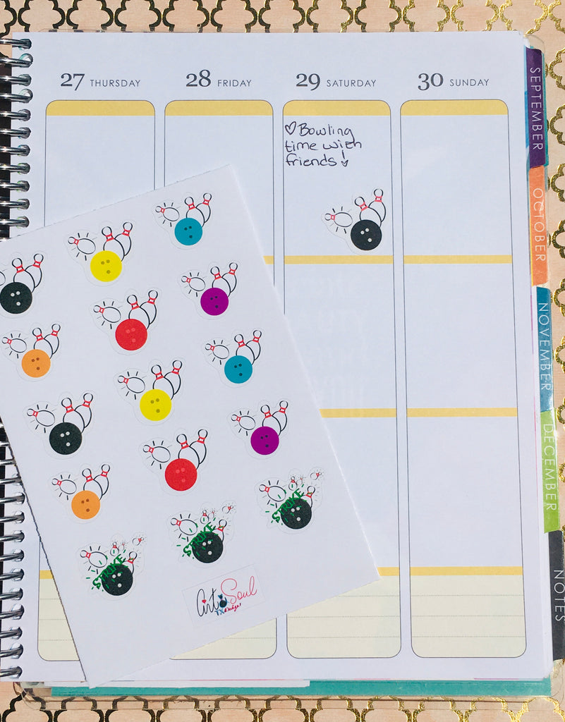 An Erin Condren life planner open to the daily spread with a bowling sticker example.
