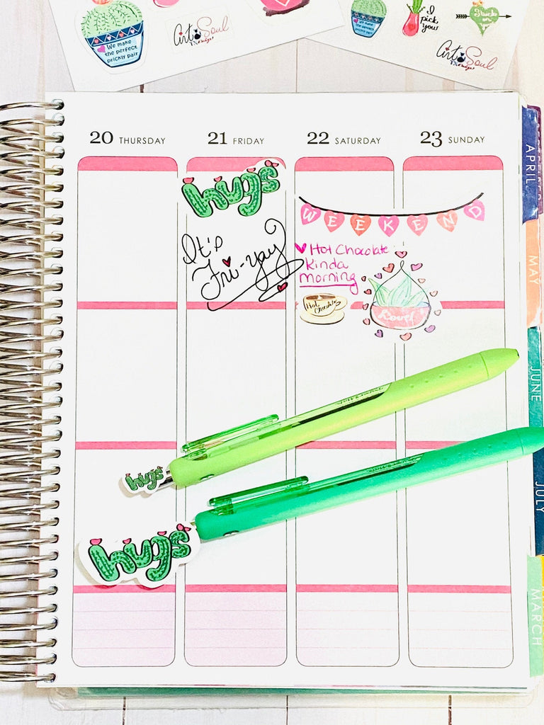 A planner with a Cactus Valentin Sticker that says "Hugs".  It's Fri-Yay" is written in the planner along with other Valentine's Day stickers.